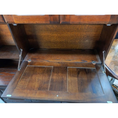 777 - A dark oak wall unit sideboard with leaded glass doors