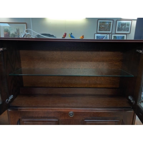 777 - A dark oak wall unit sideboard with leaded glass doors