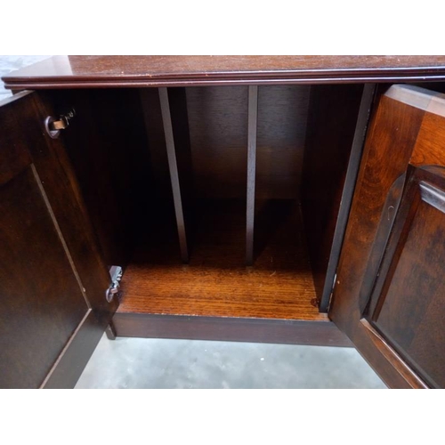 777 - A dark oak wall unit sideboard with leaded glass doors