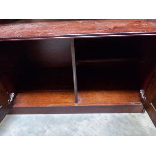 777 - A dark oak wall unit sideboard with leaded glass doors