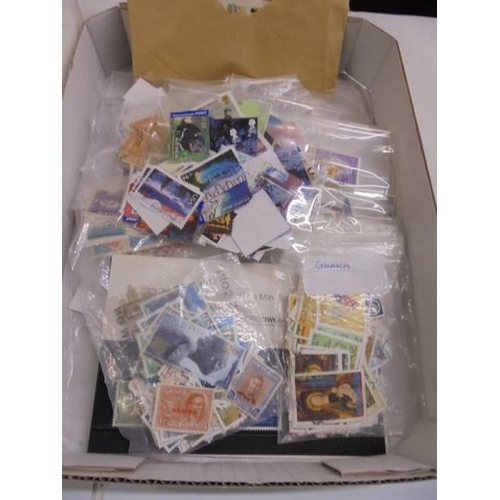 1180 - Two trays of assorted postage stamps.