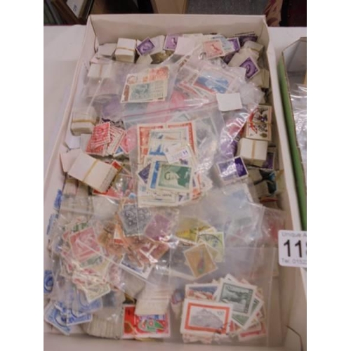 1180 - Two trays of assorted postage stamps.