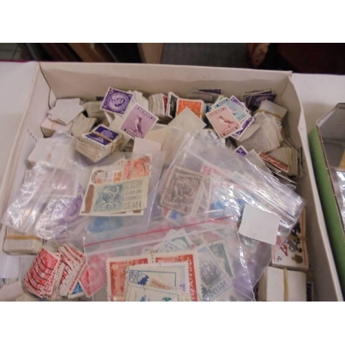 1180 - Two trays of assorted postage stamps.