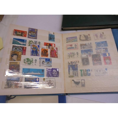 1181 - Three albums of assorted postage stamps.