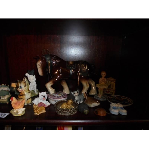 592 - Two shelves of assorted figures etc.,