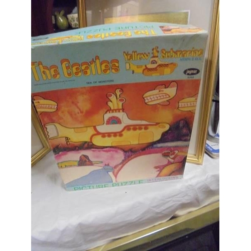 620 - A Beatles Yellow Submarine jigsaw puzzle, Beatles videos etc.,