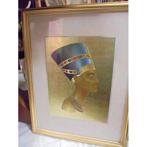 622 - A framed and glazed print of Tut-ankh-amun and another of Nefertiti.