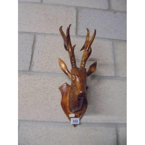 509 - A wooden wall hanging stags head.