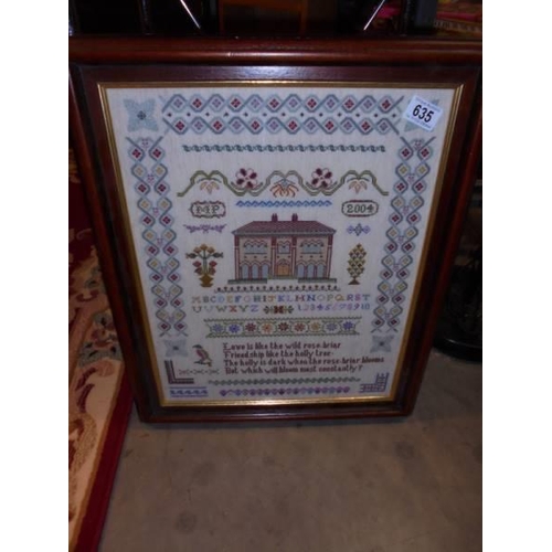 635 - A modern framed and glazed sampler.