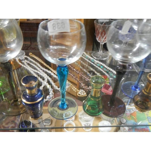 638 - A quantity of coloured glass drinking glasses and miniature vases.