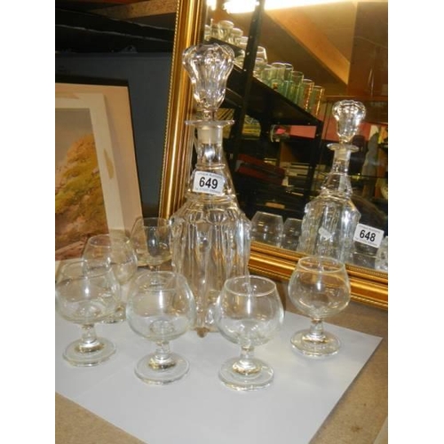 649 - A decanter and six glasses.