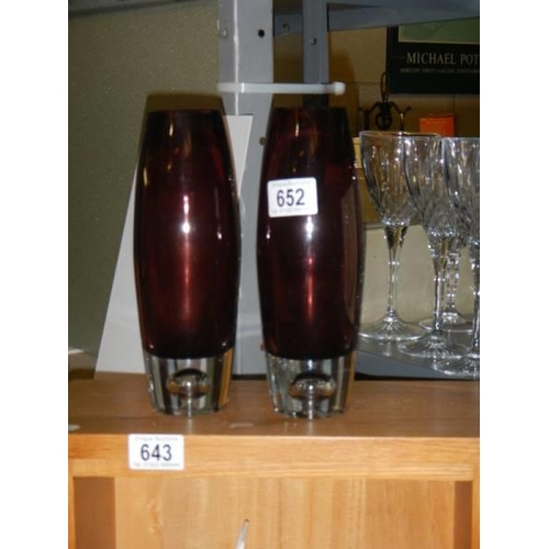 652 - A pair of amethyst coloured glass vases.