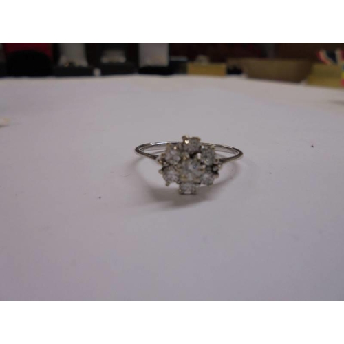 1019 - An 18ct white gold diamond floral ring of half carat, size P half.