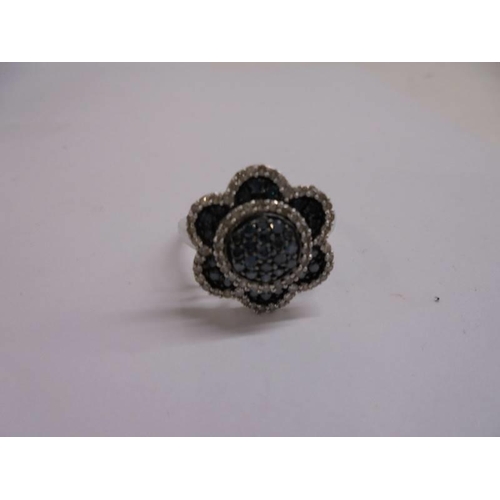 1023 - A yellow gold blue and white diamonds floral ring, size R.