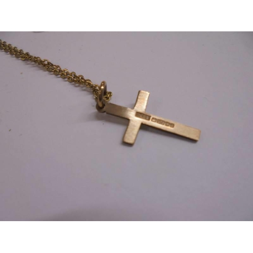 1036 - A 9ct gold cross on un-marked yellow metal chain.