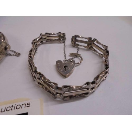 1037 - A silver gate bracelet with padlock and a silver bangle,