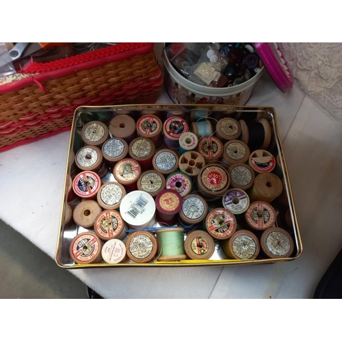 663 - A sewing box, box of cotton reels, box of buttons etc