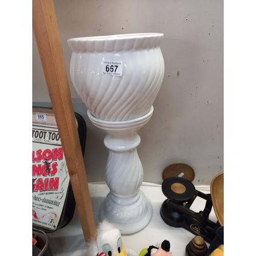 667 - A white pottery jardiniere on stand