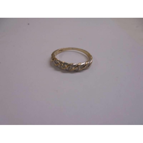 1051 - A diamond set band ring set with ten diamonds in 9ct gold, size O, 1.7 grams.