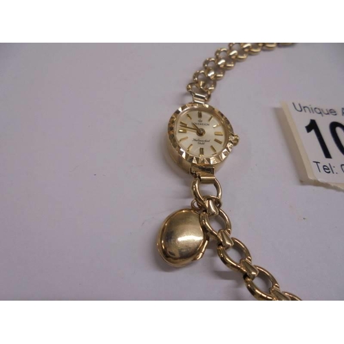 1060 - A 9ct gold watch on a 9ct gold bracelet with attached opening locker, 11 grams.