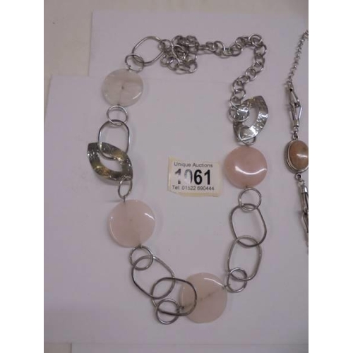 1061 - A rose quartz necklace together with another necklace.