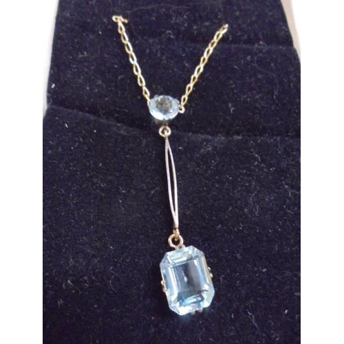 1062 - A 9ct gold drop pendant set blue stone, stamped 9ct.