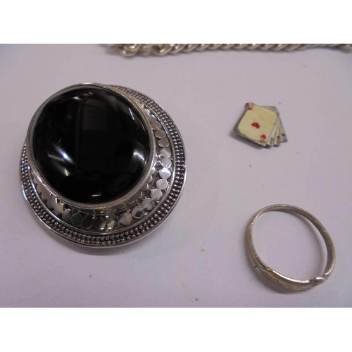 1067 - A silver kerb bracelet, silver brooch set onyx, silver pendant, silver ring and silver charm.