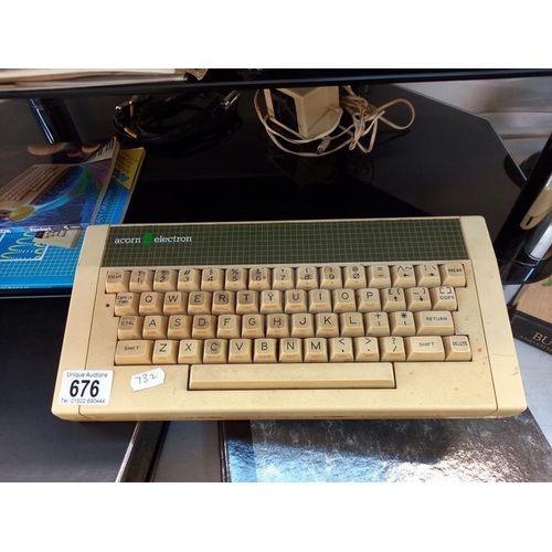 676 - A vintage Acorn electron computer with games (paintbox missing 1 cassette)