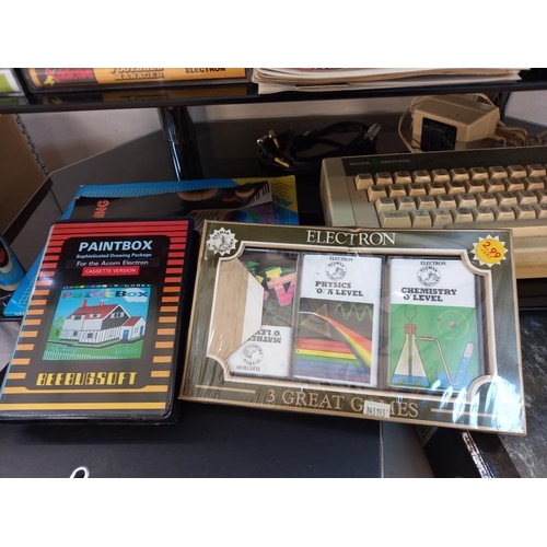 676 - A vintage Acorn electron computer with games (paintbox missing 1 cassette)