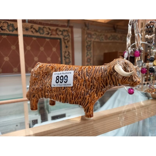 899 - A signed pottery Highland cattle ornament