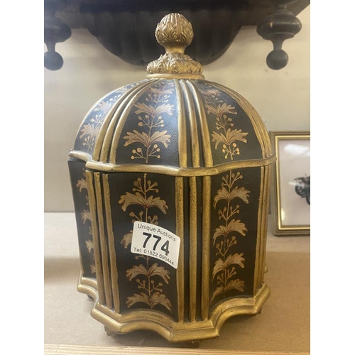 774 - An unusual shaped black & gilded box, lid has small chip