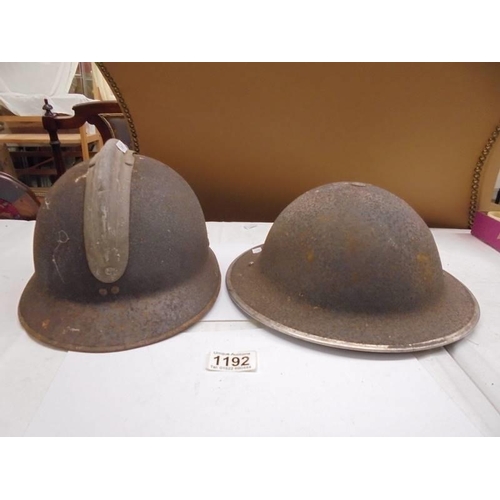 1192 - Two metal helmets.