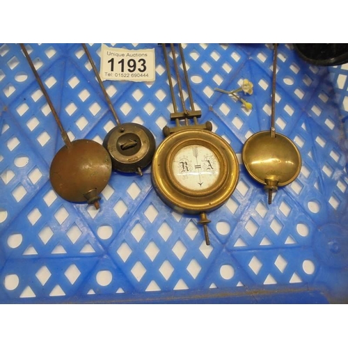 1193 - Two clock movements and four pendulums.