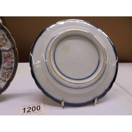 1200 - A pair of early Chinese hard paste porcelain plates with centre crests.