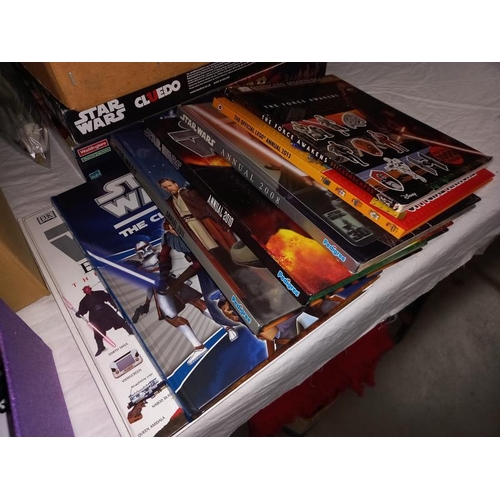 102 - A collection of Star Wars items including figures, cards, books & games including Monopoly & model k... 