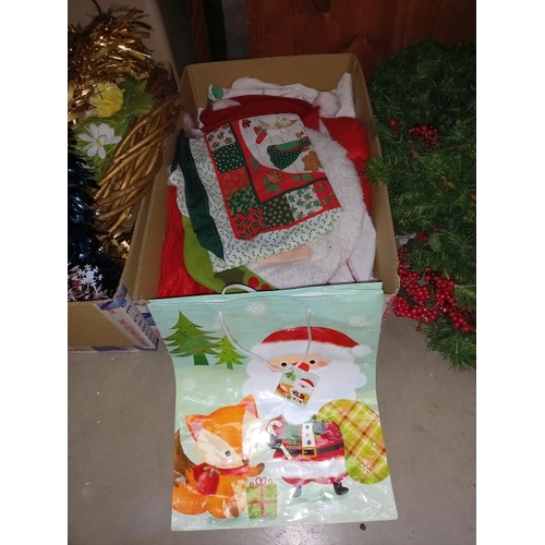 117 - A large lot quantity of miscellaneous Christmas items including hats, stockings, wreaths & wrapping ... 