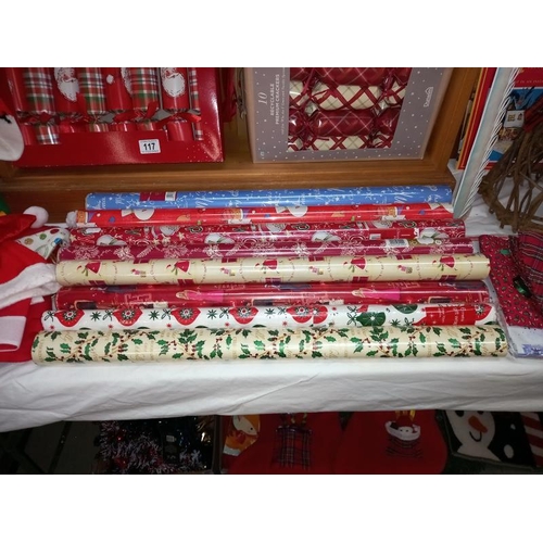 117 - A large lot quantity of miscellaneous Christmas items including hats, stockings, wreaths & wrapping ... 