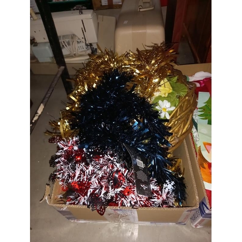 117 - A large lot quantity of miscellaneous Christmas items including hats, stockings, wreaths & wrapping ... 