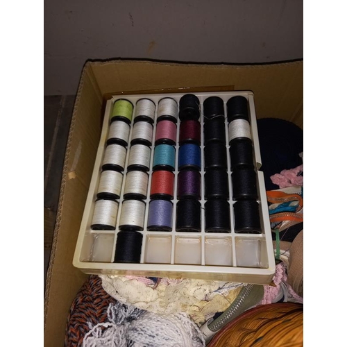 50 - A box of vintage sewing items including cotton reels, wicker basket, knitting needles etc