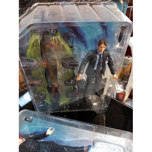 74 - A Barbie and Ken The X-Files gift set and 4 X files figures, all boxed