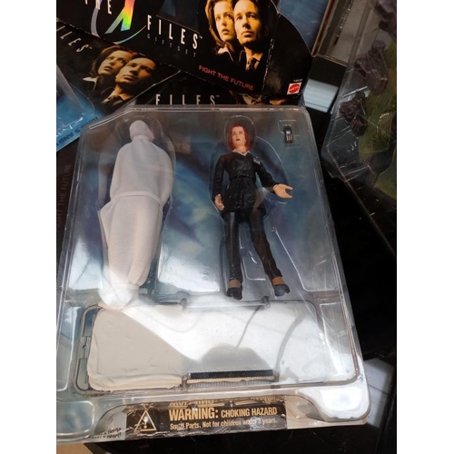 74 - A Barbie and Ken The X-Files gift set and 4 X files figures, all boxed