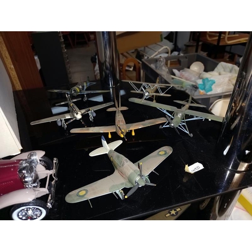 75 - A boxed Franklin Mint car and a collection of made and hand painted model aeroplanes