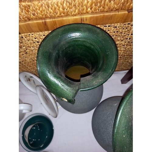 179 - A pair of green pottery vases, 41cm high