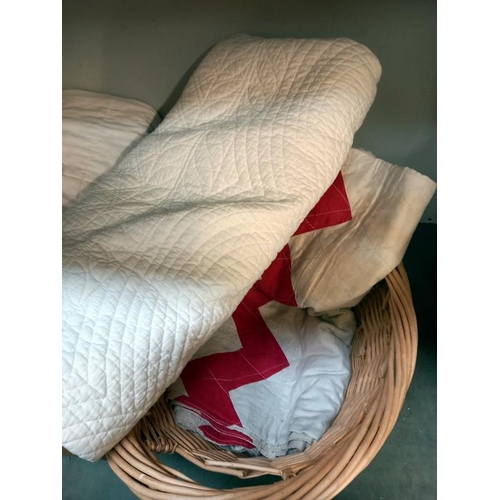 198 - A basket & box of bed spread quilts