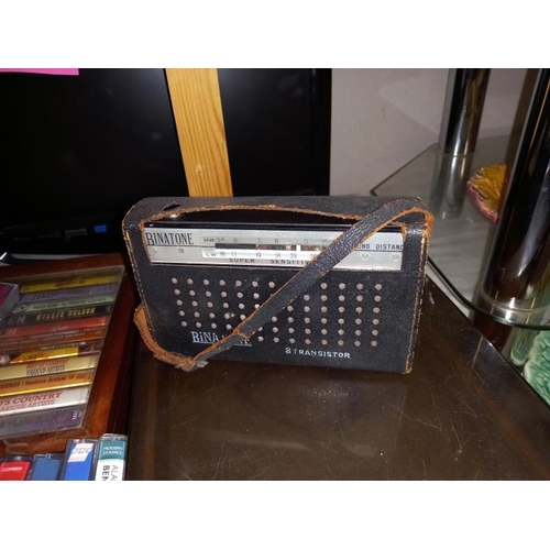 209 - A vintage Binatone transistor radio & varied selection of music cassettes