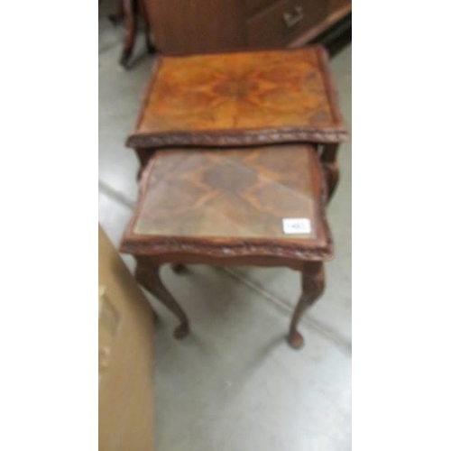 1483 - A nest of two walnut veneer tables, missing one glass top. COLLECT ONLY.