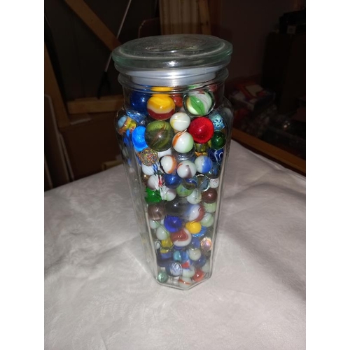 313 - 2 large glass containers of marbles & a Caithness paperweight