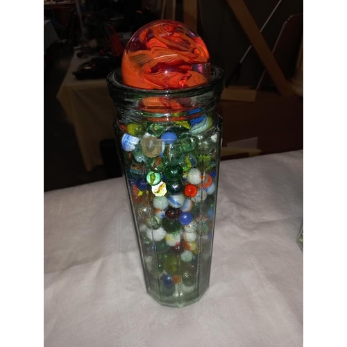 313 - 2 large glass containers of marbles & a Caithness paperweight