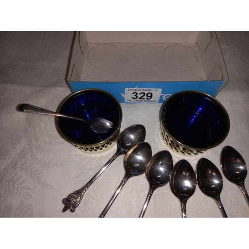 329 - A pair of silver plate salts with blue glass liners & 6 boy scout spoons