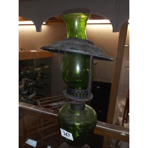 347 - A vintage green glass & black steel oil lamp